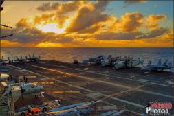 The sun sets with dramatic colors and rays of light over the flight deck of the USS Abraham Lincoln (CVN-72) as seen from Vultures Row - Photo by Britt Dietz The sun sets with dramatic colors and rays of light over the flight deck of the USS Abraham Lincoln (CVN-72) as seen from Vultures Row - Photo by Britt Dietz